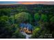Areal image of custom home nestled in green space with beautiful trees and meticulous landscaping at 10723 Green Heron Ct, Charlotte, NC 28278