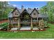 Gorgeous home featuring a stone foundation, wood siding, a large balcony, and sprawling green space at 10723 Green Heron Ct, Charlotte, NC 28278