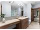 Modern bathroom featuring stone countertops, framed mirror, and sleek lighting at 10723 Green Heron Ct, Charlotte, NC 28278