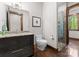 Bathroom with framed mirror, sleek vanity, glass shower, and wood accents at 10723 Green Heron Ct, Charlotte, NC 28278