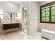 Modern bathroom with a floating vanity, glass-enclosed shower, and natural stone accents at 10723 Green Heron Ct, Charlotte, NC 28278