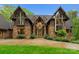 Detailed exterior view of a stone and timber home, highlighting the architectural design and landscaping at 10723 Green Heron Ct, Charlotte, NC 28278