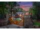 Beautiful stone and wooden gate leading to the home, surrounded by lush greenery and landscaping at 10723 Green Heron Ct, Charlotte, NC 28278