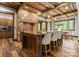 Well-appointed kitchen with a large island, stone accents, wooden ceiling beams, and a dining area at 10723 Green Heron Ct, Charlotte, NC 28278