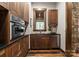 Cozy kitchenette with wooden cabinets, granite countertops, stainless steel appliances, and a window view at 10723 Green Heron Ct, Charlotte, NC 28278
