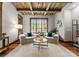 Cozy living room with rustic ceiling, comfortable seating, and natural light from a large window at 10723 Green Heron Ct, Charlotte, NC 28278