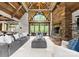 Bright living room with a stone fireplace, high ceilings, wood beams, and a view to the outside deck at 10723 Green Heron Ct, Charlotte, NC 28278