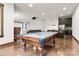 Entertaining space with pool table, kitchen, projector, and seating area at 10723 Green Heron Ct, Charlotte, NC 28278