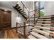 Unique floating staircase featuring modern design and wood and metal finishes at 10723 Green Heron Ct, Charlotte, NC 28278
