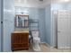 Bathroom with a vanity, toilet, and a shelf for storage, plus an open door at 1113 Urban Pl, Charlotte, NC 28209