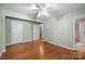 Hardwood bedroom with three doors leading to a bathroom and hall with neutral paint at 1113 Urban Pl, Charlotte, NC 28209