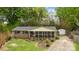 Aerial view of charming brick home with a screened-in back porch and a long driveway at 1113 Urban Pl, Charlotte, NC 28209
