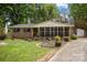 Charming brick home with a screened-in front porch and long driveway at 1113 Urban Pl, Charlotte, NC 28209