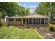 Charming brick home with a screened-in front porch and landscaped front yard at 1113 Urban Pl, Charlotte, NC 28209