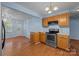 Bright kitchen featuring wooden cabinets, stainless steel appliances, and hardwood floors, offering functionality and style at 1113 Urban Pl, Charlotte, NC 28209