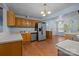 Well-lit kitchen boasts wooden cabinetry, stainless steel appliances, and hardwood floors, perfect for cooking and entertaining at 1113 Urban Pl, Charlotte, NC 28209