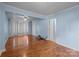 Open-concept living room with hardwood floors, ceiling fan, and access to other rooms at 1113 Urban Pl, Charlotte, NC 28209