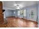 Bright living room with hardwood floors, large windows, and neutral paint at 1113 Urban Pl, Charlotte, NC 28209