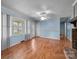 Bright living room with hardwood floors, large windows, and an open door at 1113 Urban Pl, Charlotte, NC 28209