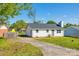 Charming single-story home with white siding, a driveway, a green lawn, and mature trees, presenting a welcoming curb appeal at 1153 Doris Ct, Rock Hill, SC 29730