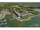 Stunning aerial view of lakeside condos with mature trees, boat docks, and lovely green spaces at 1211 Torrence Cir, Davidson, NC 28036