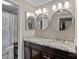 Bathroom featuring double sinks with granite countertops, modern fixtures, and ample lighting at 1211 Torrence Cir, Davidson, NC 28036