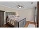 Bedroom with hardwood floors, ceiling fan, and warm neutral tones to create a cozy atmosphere at 1211 Torrence Cir, Davidson, NC 28036