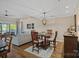 Dining area next to a living room with hardwood floors and water views at 1211 Torrence Cir, Davidson, NC 28036