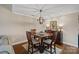 Inviting dining area with modern lighting and views into the cozy living room at 1211 Torrence Cir, Davidson, NC 28036