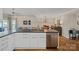 Island kitchen with bar seating overlooks dining area and bright living room at 1211 Torrence Cir, Davidson, NC 28036