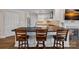 A modern kitchen boasts a black countertop island, stainless steel appliances, and a stylish backsplash at 1211 Torrence Cir, Davidson, NC 28036