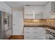 Modern kitchen with white cabinets, stainless steel refrigerator, and mosaic backsplash at 1211 Torrence Cir, Davidson, NC 28036