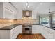 Sleek kitchen with stainless steel range, mosaic backsplash, and white cabinets at 1211 Torrence Cir, Davidson, NC 28036