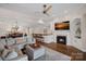 Bright living room featuring fireplace, ceiling fan, wood floors and open to kitchen and dining areas at 1211 Torrence Cir, Davidson, NC 28036