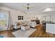 A living room with hardwood floors, a ceiling fan, an area rug and a comfortable couch at 1211 Torrence Cir, Davidson, NC 28036