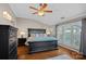 Bedroom with wood flooring, fan, and large windows offering natural light and a view at 1211 Torrence Cir, Davidson, NC 28036