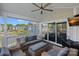 Inviting porch with comfortable seating, ceiling fan, and a view of the community pond and neighborhood at 1211 Torrence Cir, Davidson, NC 28036