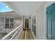 Well-lit building walkway with front door and white support columns and visible unit number at 1211 Torrence Cir, Davidson, NC 28036