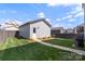 Landscaped backyard with well-maintained lawn, privacy fence and detached garage at 13813 Jacks Ln, Pineville, NC 28134