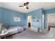 Bedroom with blue walls, reading materials and nearby bathroom at 13813 Jacks Ln, Pineville, NC 28134