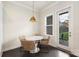 Cozy dining area with wicker chairs, a modern light fixture, and patio access at 13813 Jacks Ln, Pineville, NC 28134