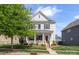 Beautiful two-story home boasts a front porch, well-maintained lawn, and inviting curb appeal at 13813 Jacks Ln, Pineville, NC 28134