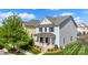Inviting two-story home displays a charming front porch and manicured lawn at 13813 Jacks Ln, Pineville, NC 28134