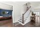Elegant foyer showcasing hardwood floors, a staircase with white railings, and a view into the living room at 13813 Jacks Ln, Pineville, NC 28134