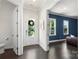 Bright foyer with hardwood floors, a glass-paneled front door, and an entrance to a living area at 13813 Jacks Ln, Pineville, NC 28134