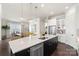 Open concept kitchen with black island, white countertops, and pendant lighting at 13813 Jacks Ln, Pineville, NC 28134