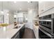 Bright kitchen with an island, stainless steel appliances, and white cabinets at 13813 Jacks Ln, Pineville, NC 28134