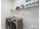 Functional laundry room with shelving and modern washer and dryer at 13813 Jacks Ln, Pineville, NC 28134