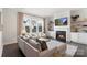 Comfortable living room with a fireplace, large windows, and neutral decor at 13813 Jacks Ln, Pineville, NC 28134