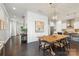 Bright open-concept living space includes kitchen, dining, and living areas with hardwood floors and modern decor at 13813 Jacks Ln, Pineville, NC 28134